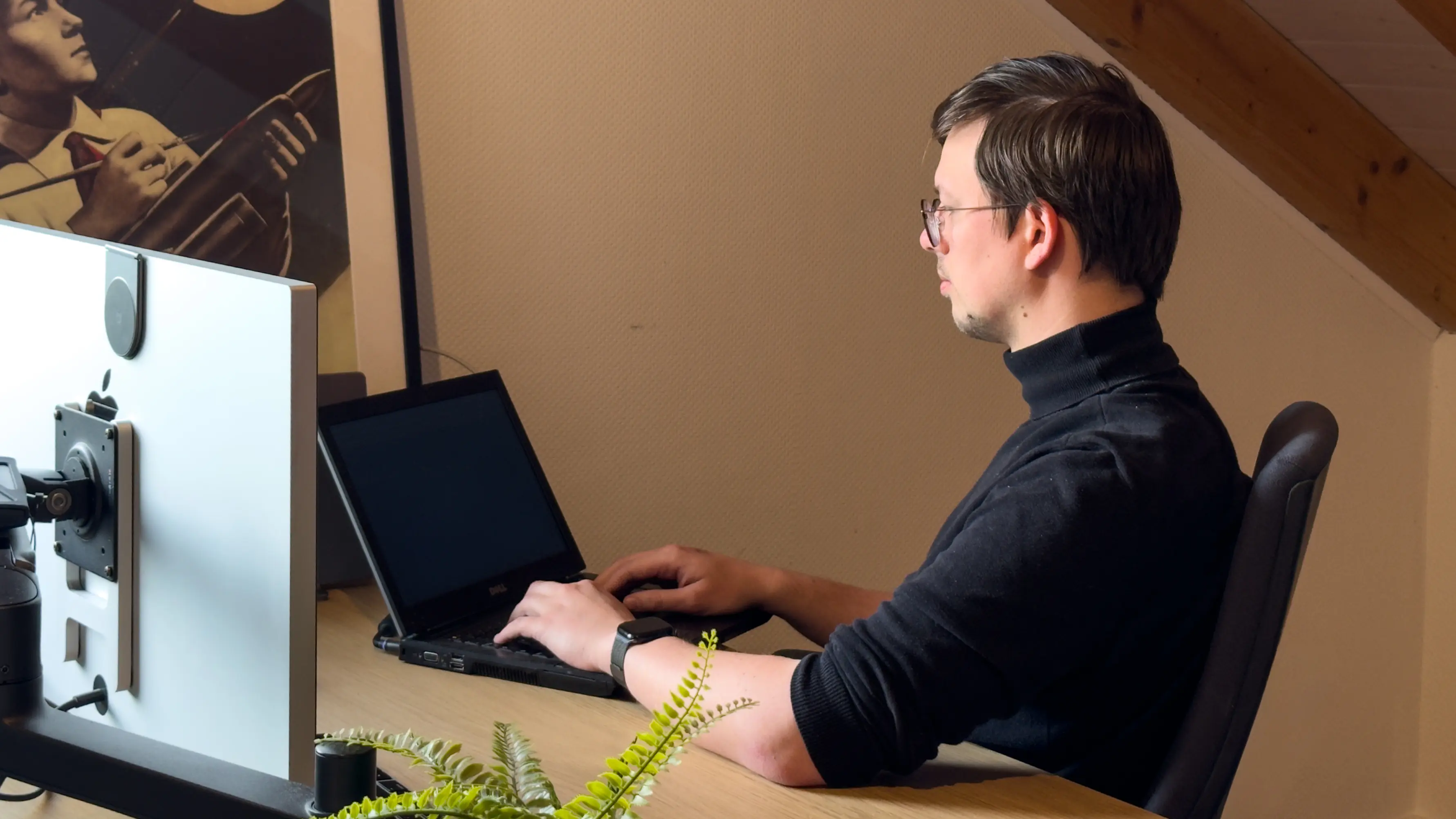 Founder coding on an old laptop while testing the stack
